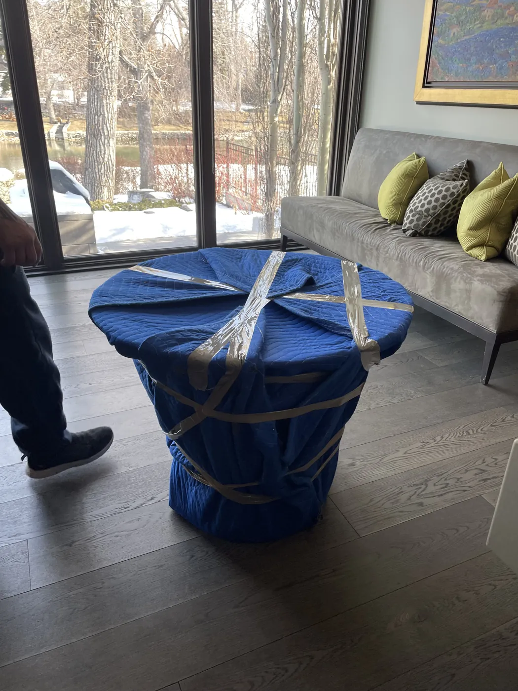 Chairs protected with padded moving blankets inside a home