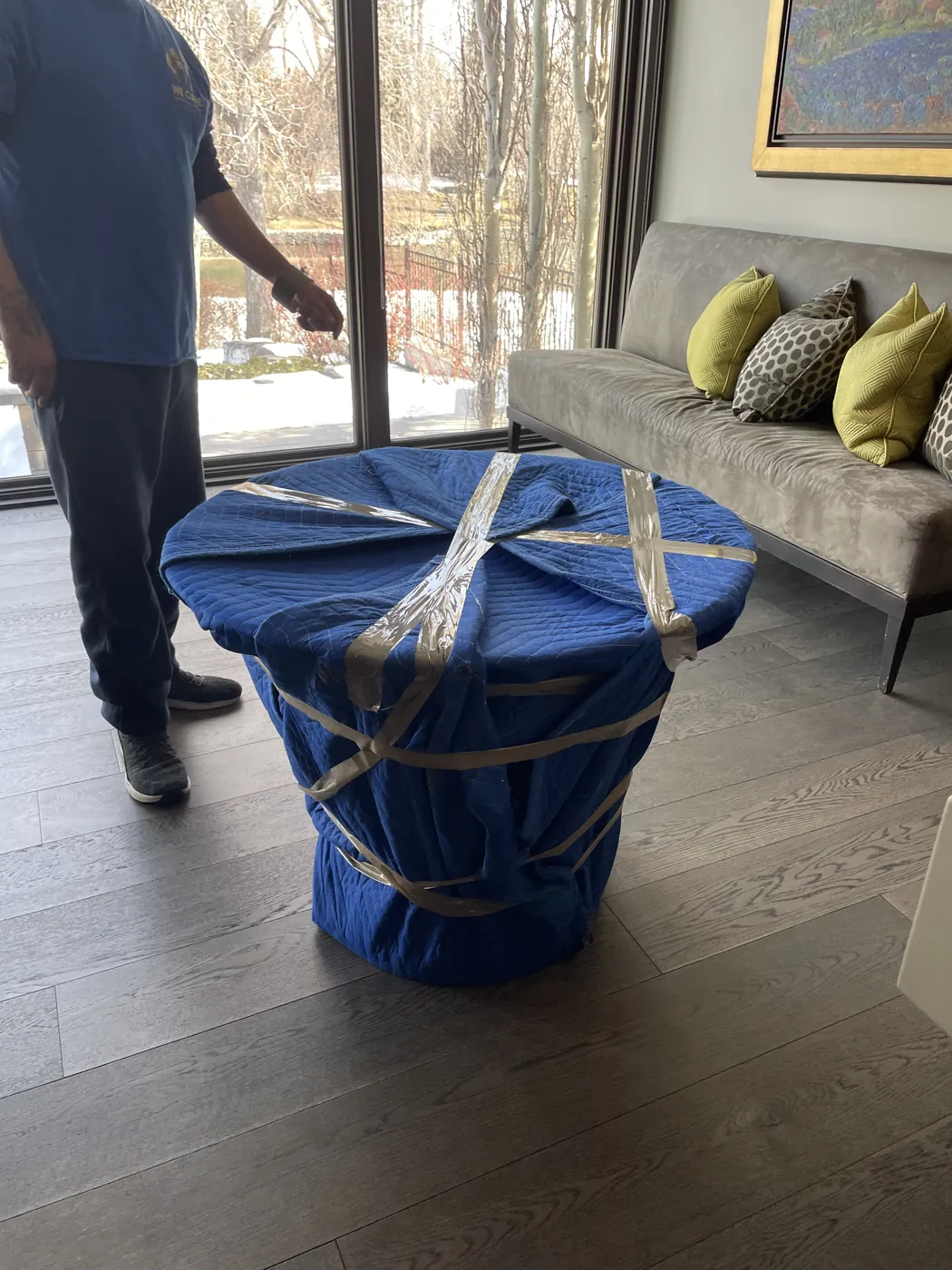 Chairs protected with padded moving blankets inside a home